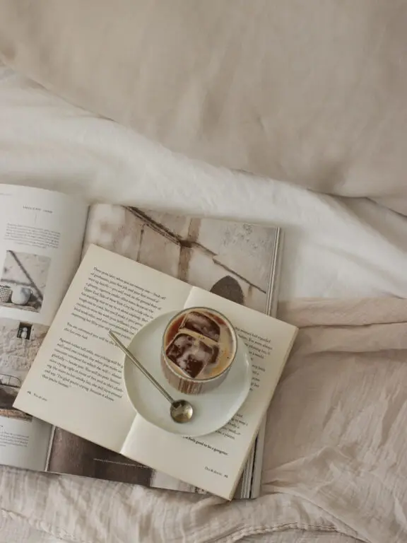 Book placed on a styled bed as part of pre-listing home consultations by Pair Home Design.